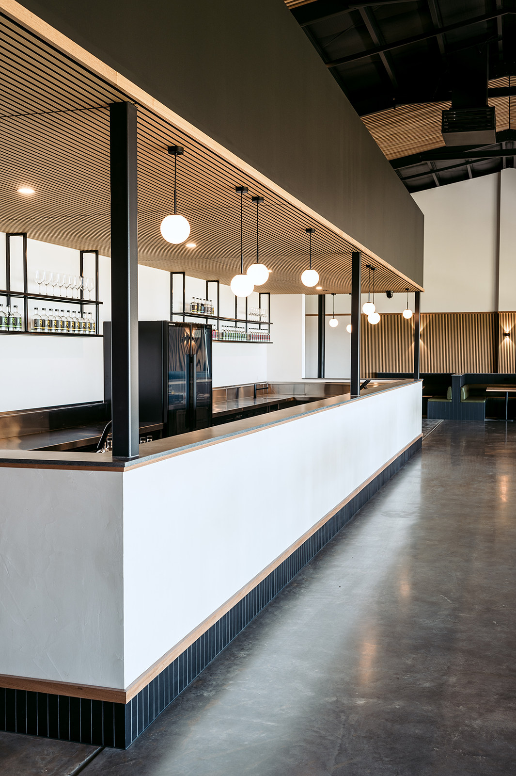 Port Elliot Stays, white bar counter beneath a timber ceiling